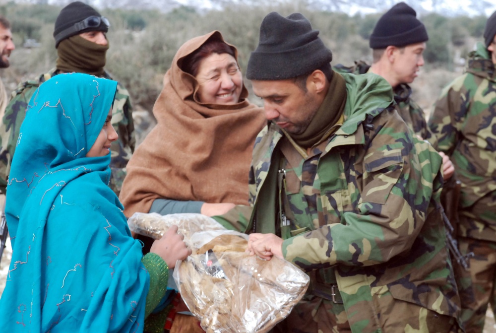 Afghan Soldier Provides Clothing to Girl During Humanitarian Visit