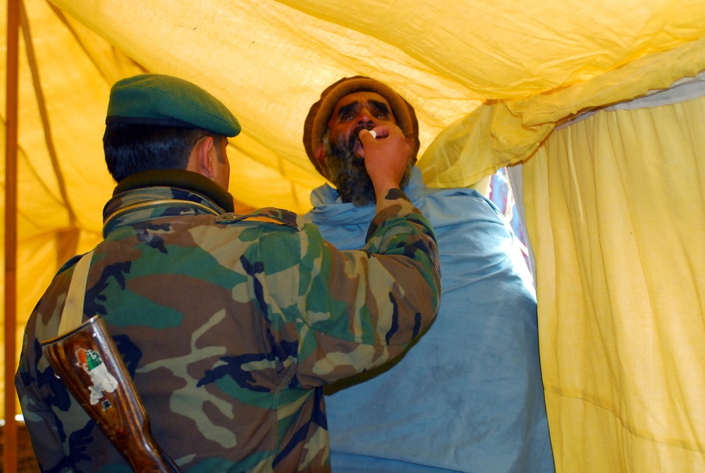 Afghan Soldier Provides Medical Aid to Villager