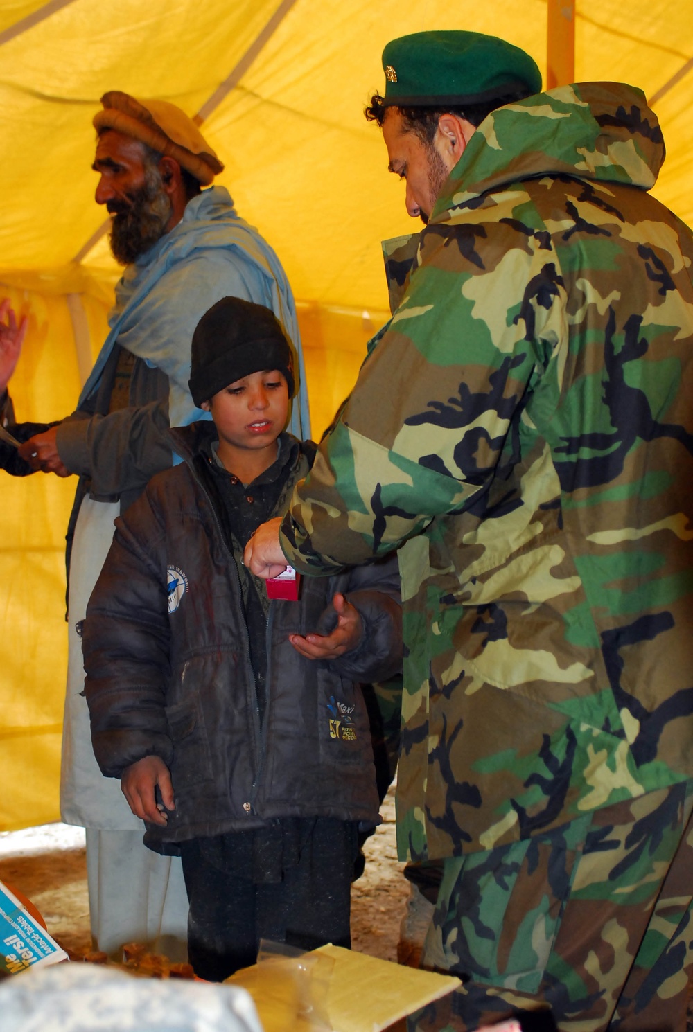 Afghan Army Captain Provides Medical Aid to Local Boy