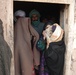 Afghan Grandmother Cradles Newborn Grandchild as Mother Transported to Hospital