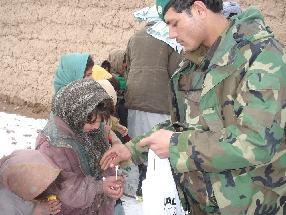 Afghan Soldier Distributes Candy to Children in Herat Province