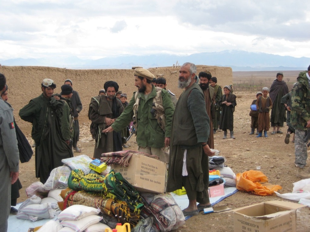 Afghan Security Forces Assist Villagers with Humanitarian Aid Distribution