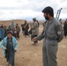 Afghan Policeman Greets Boy During Village Visit in Oruzgan Province