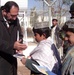 Afghan Girl Receives Coloring Book from Army Soldiers