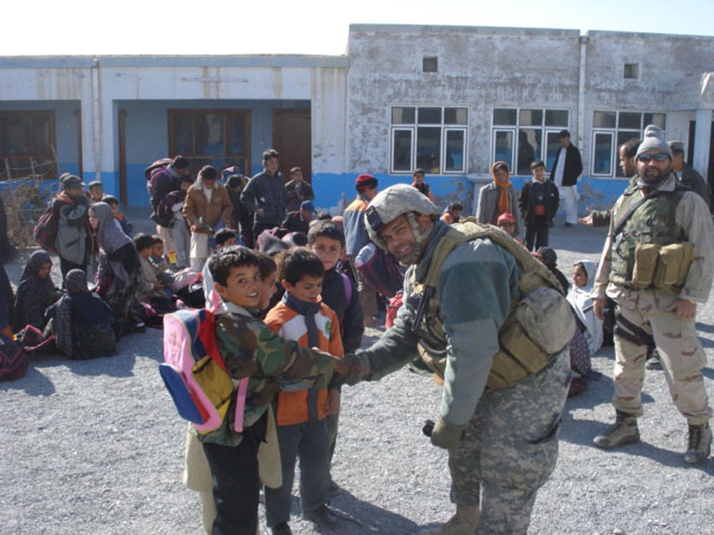 Coalition Soldier Greets Afghan Boys at Orphanage in Kandahar