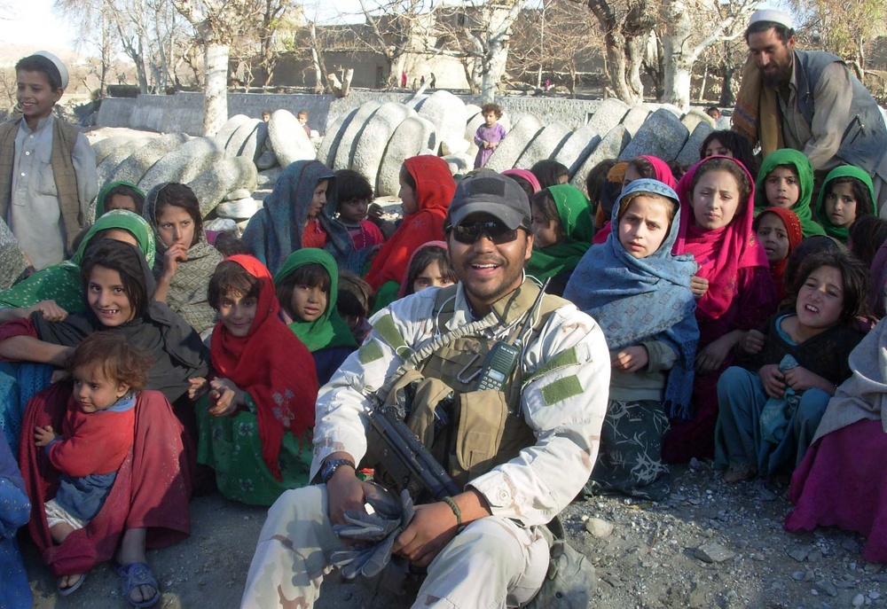 Afghan Police Officer Distributes Toys to Children in Nangarhar Province