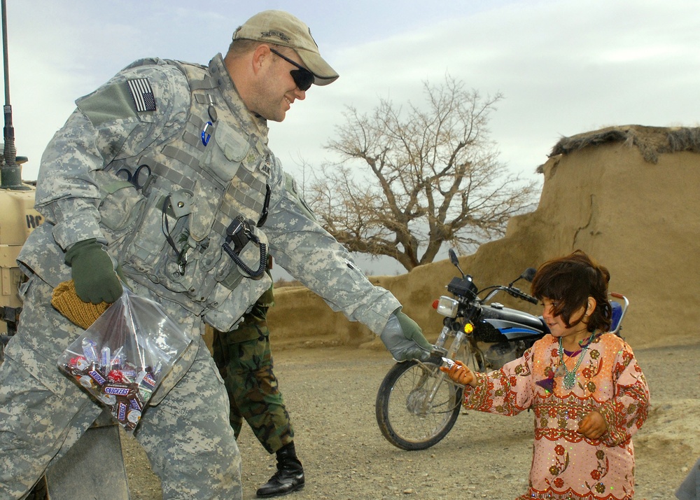U.S. Army Major Distributes Candy to Afghan Villagers in Humanitarian Outreach