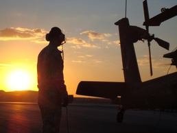 Apache Longbow Crew Chief Prepares Helicopter for Night Mission in Iraq
