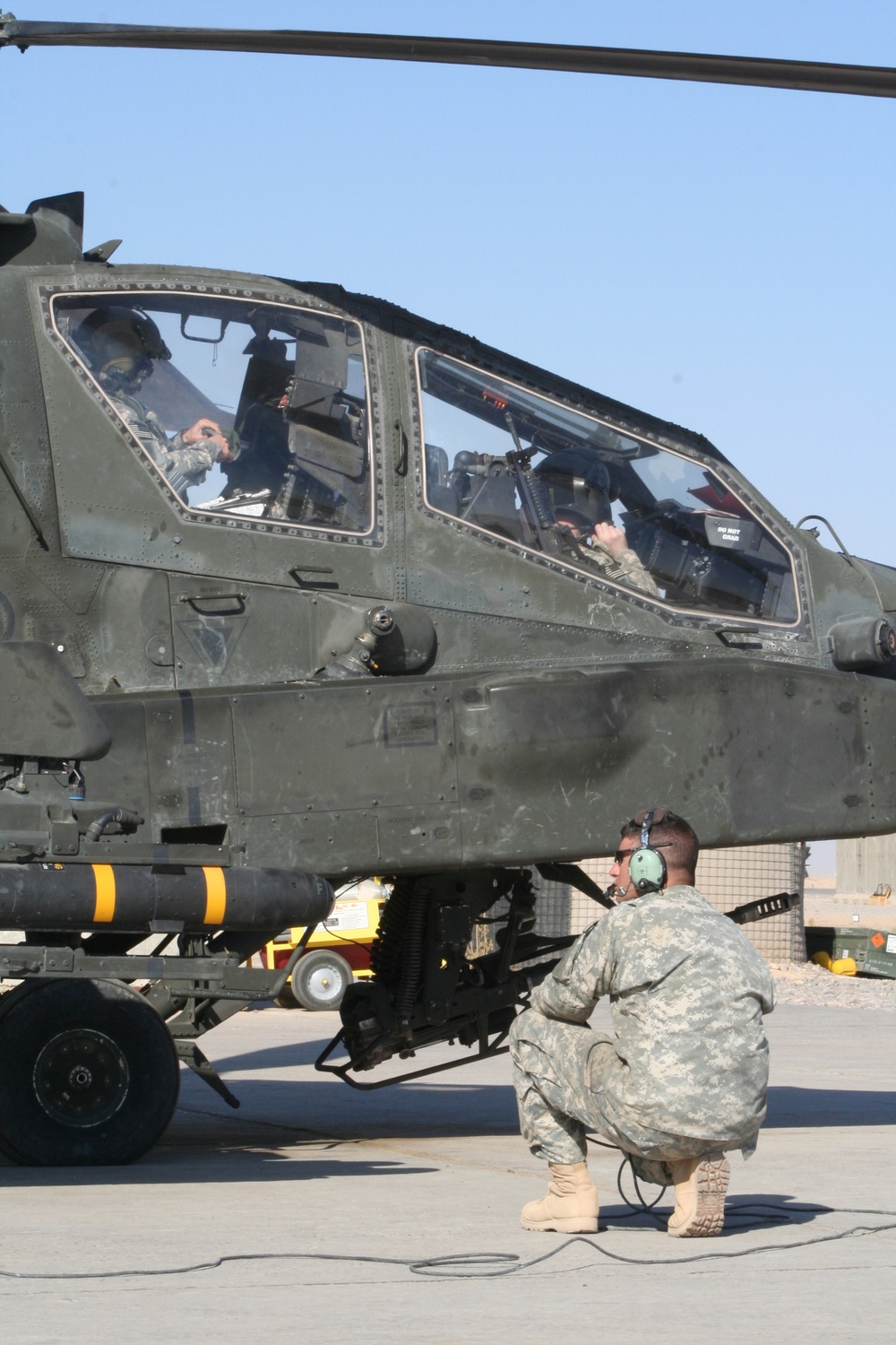 Apache Longbow Crew Chief Prepares Helicopter Gunship for Mission in Iraq
