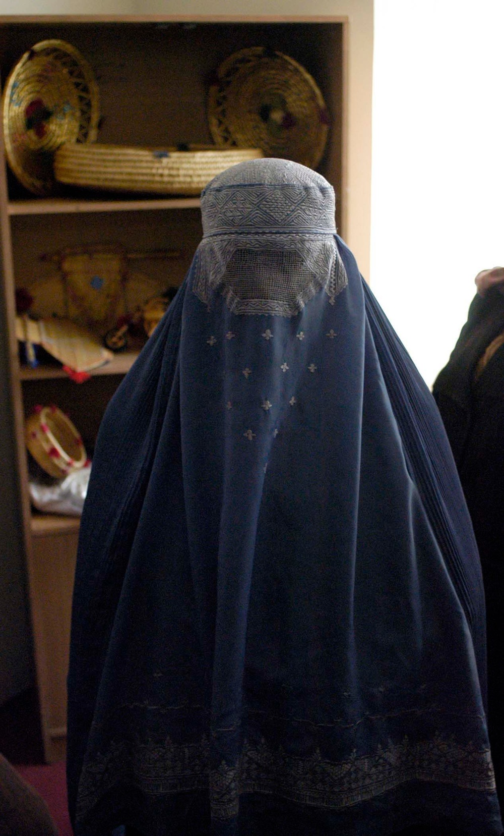 Afghan Woman Sells Handmade Crafts at Women's Shelter Opening