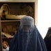 Afghan Woman Sells Handmade Crafts at Women's Shelter Opening
