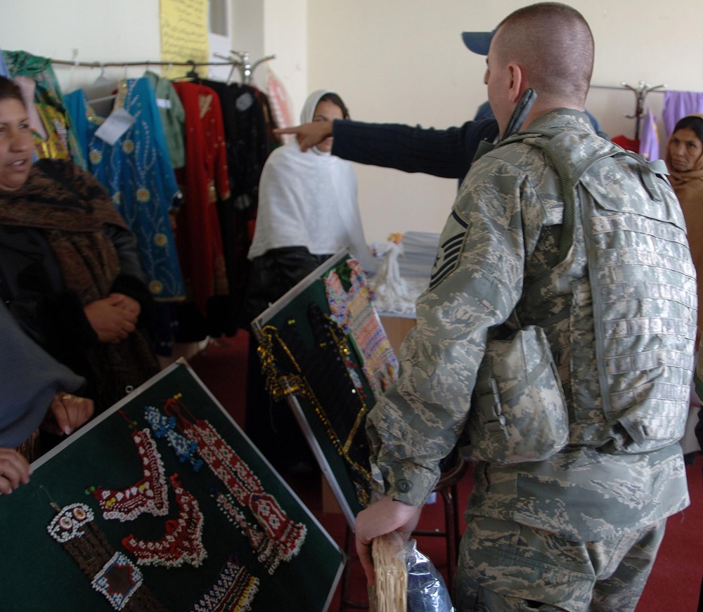 Air Force Master Sgt. Examines Handmade Crafts at Women's Shelter Opening in Afghanistan