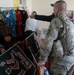 Air Force Master Sgt. Examines Handmade Crafts at Women's Shelter Opening in Afghanistan