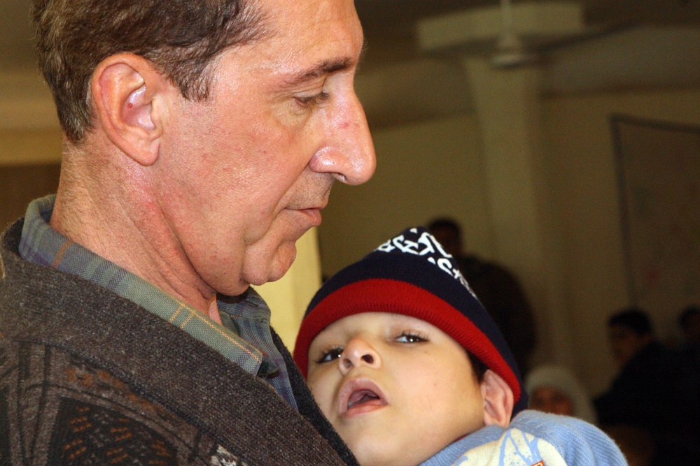 Iraqi Father Awaits New Wheelchair for Son with Cerebral Palsy
