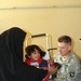 U.S. Army Medic Assists Iraqi Civilian with Wheelchair Adjustments