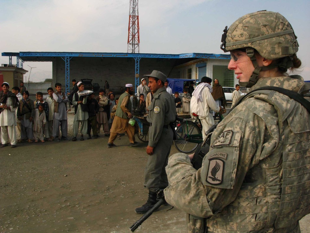 U.S. Soldier Provides Security with Afghan Police After First Aid Training