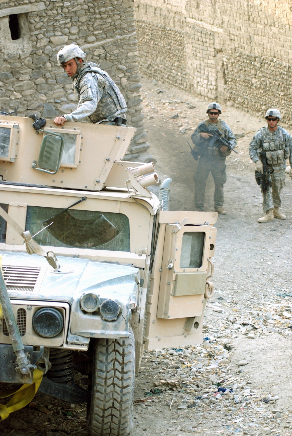 U.S. Troops Guide Humvee Through Afghan Village