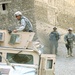 U.S. Troops Guide Humvee Through Afghan Village