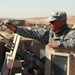 Soldier Cleans Weapon During Patrol in Afghanistan
