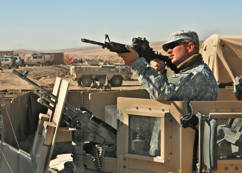 Soldier Cleans Rifle During Patrol in Afghanistan