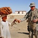 U.S. Soldier Gives Toy to Afghan Boy Outside Police Station