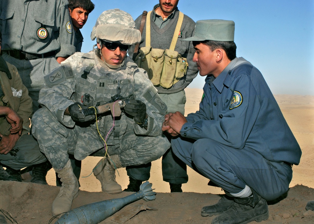 Army Captain Examines Disabled Improvised Explosive Device in Afghanistan
