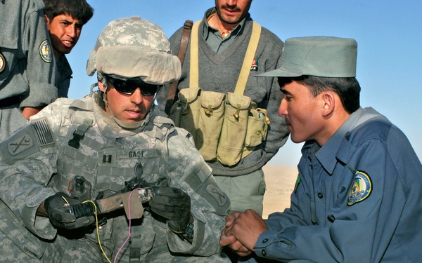 Army Captain Examines Disabled Improvised Explosive Device in Afghanistan