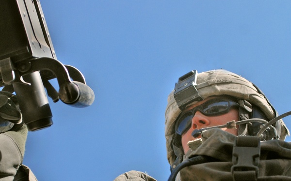 U.S. Soldier Mans .50-Caliber Turret Gun During Afghan Police Convoy