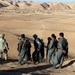 Army Captain Receives Security Update from Afghan Police During Operation