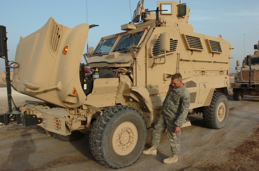 Soldier Inspects New Mine-Resistant Vehicle at Camp Liberty