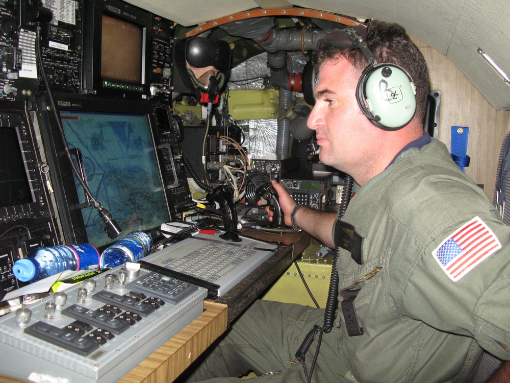 Coast Guard Petty Officer Monitors Boat Traffic from Aircraft