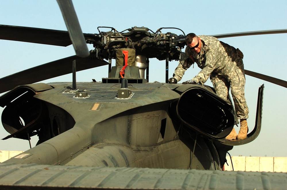 Army Officer Conducts Preflight Checks on Black Hawk Helicopter in Iraq