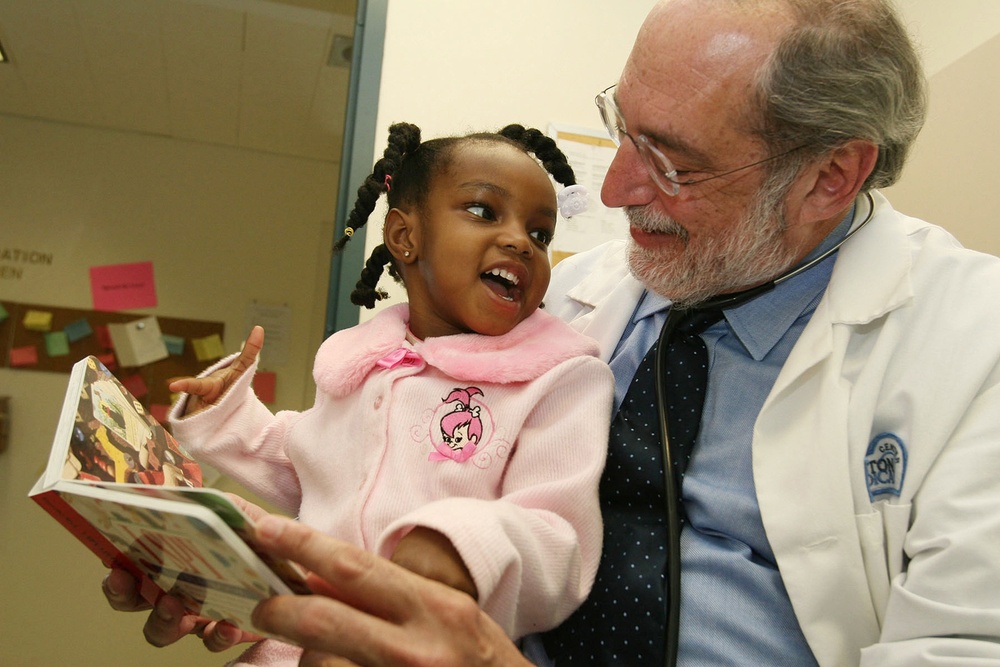 Reach Out and Read Co-Founder Reads with Young Patient at Military Medical Facility