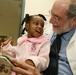 Reach Out and Read Co-Founder Reads with Young Patient at Military Medical Facility