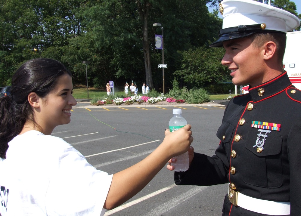 Teen Offers Water to Marine at Freedom Walk