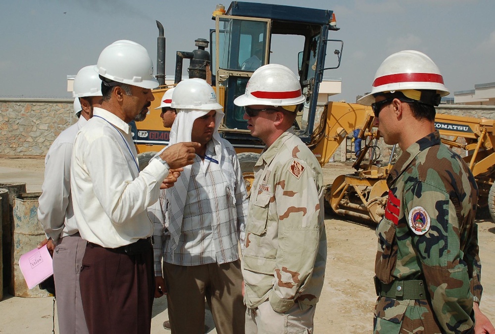 Construction Rep Discusses Issues with Contractors as Afghan Cadet Listens