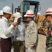 Construction Rep Discusses Issues with Contractors as Afghan Cadet Listens