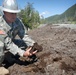 National Guard Colonel Examines Muskeg During Alaska Road Construction