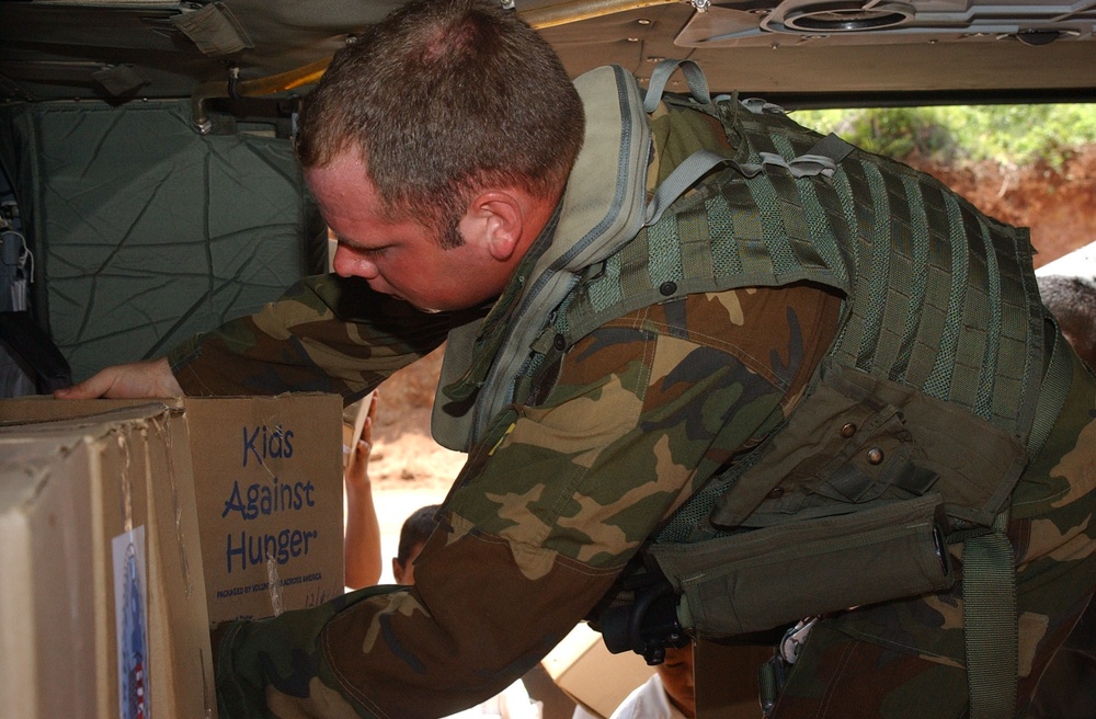 Army Crew Chief Secures Humanitarian Supplies on Black Hawk