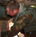 Army Crew Chief Secures Humanitarian Supplies on Black Hawk