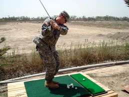 Soldier Swings Golf Club During Downtime in Iraq