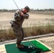 Soldier Swings Golf Club During Downtime in Iraq