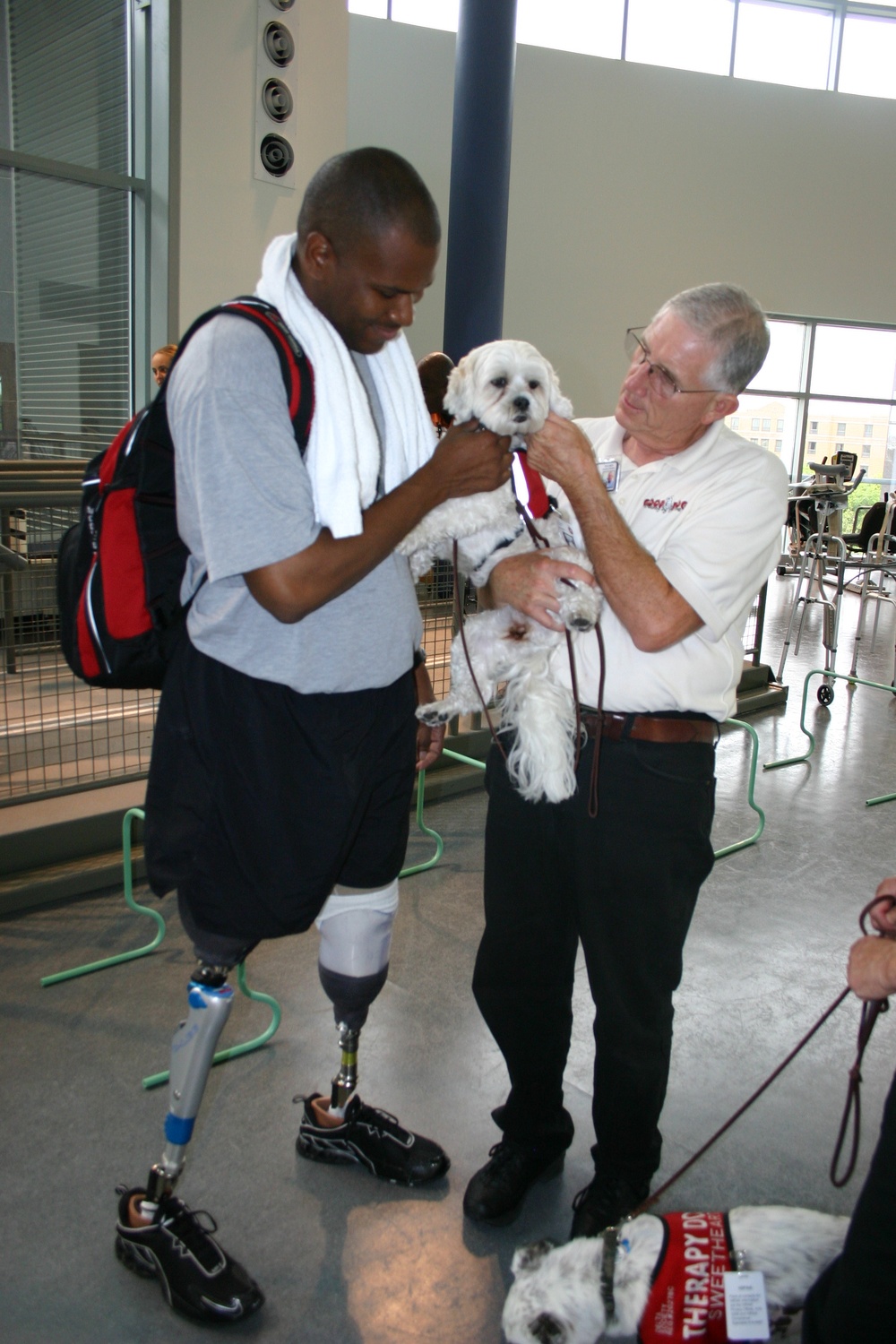 Army Soldier Bonds with Therapy Dog at Rehabilitation Center