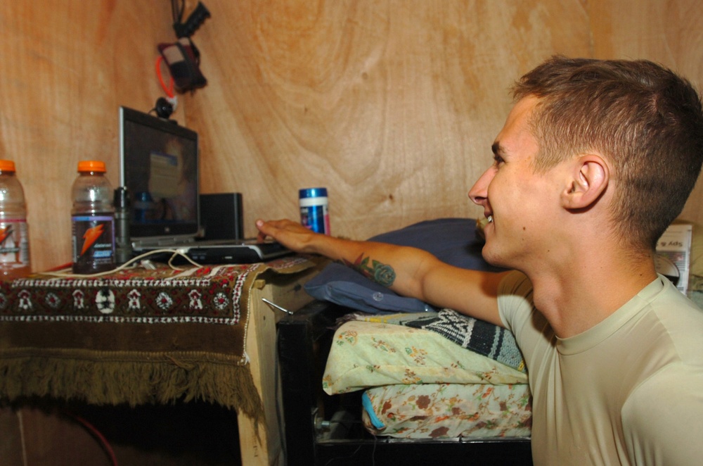 Scout Opens Computer at Coalition Outpost in Iraq