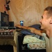 Scout Opens Computer at Coalition Outpost in Iraq