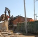 Clearing the Way: Heavy Equipment Hauls Debris at Camp Humphreys Construction Site