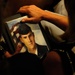 Mother Holds Painting of Son at Fallen Soldiers Exhibit Closing