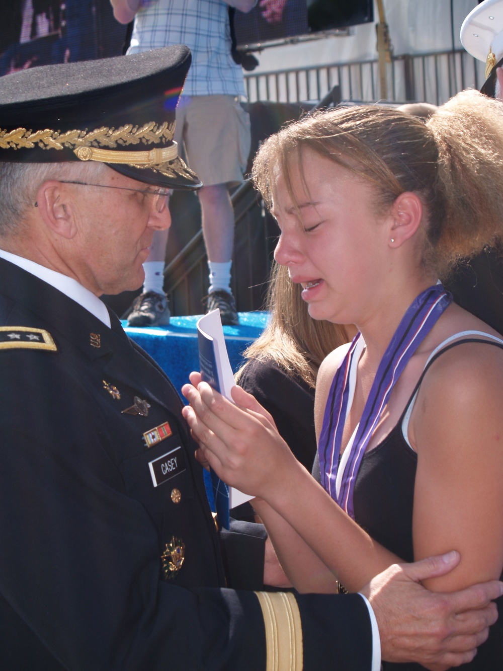 Army Chief Consoles Young Girl at Memorial Ceremony