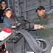 Navy Petty Officer Simulates Firing Machine Gun from Helicopter at Air Show