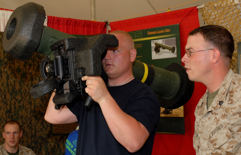 Marine Sgt. Watches as Visitor Examines Anti-Tank Missile Launcher